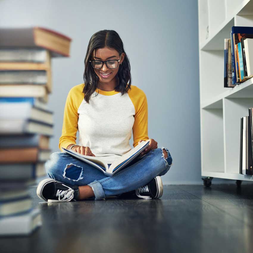 study-skills-exam-revision-coaching-girl-in-yellow Studying for finals. a young female student studying at home