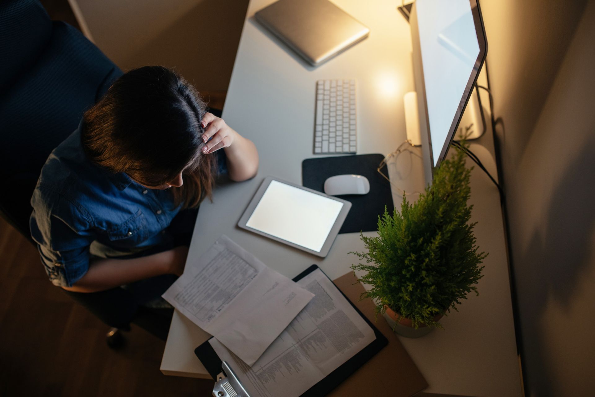 About Juliet Landau-Pope PCC Woman working late at a desk, procrastinating while studying
